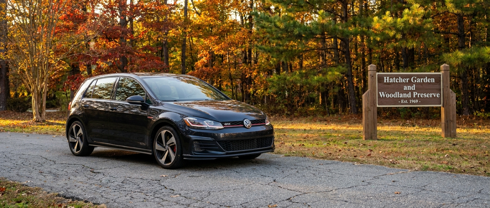 2021 Volkswagen Golf GTI in black parked at Hatcher Garden Spartanburg SC during fall foliage season