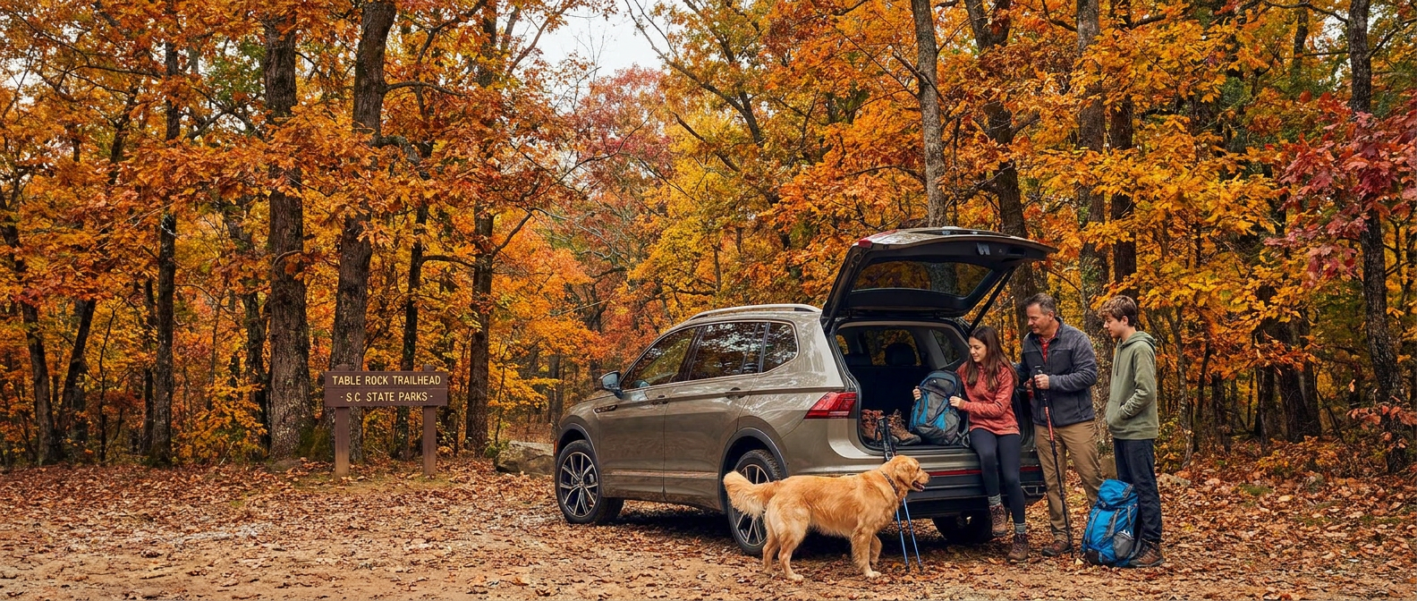 2027 Volkswagen Tiguan at Croft State Park trailhead in October with fall foliage and family unloading gear